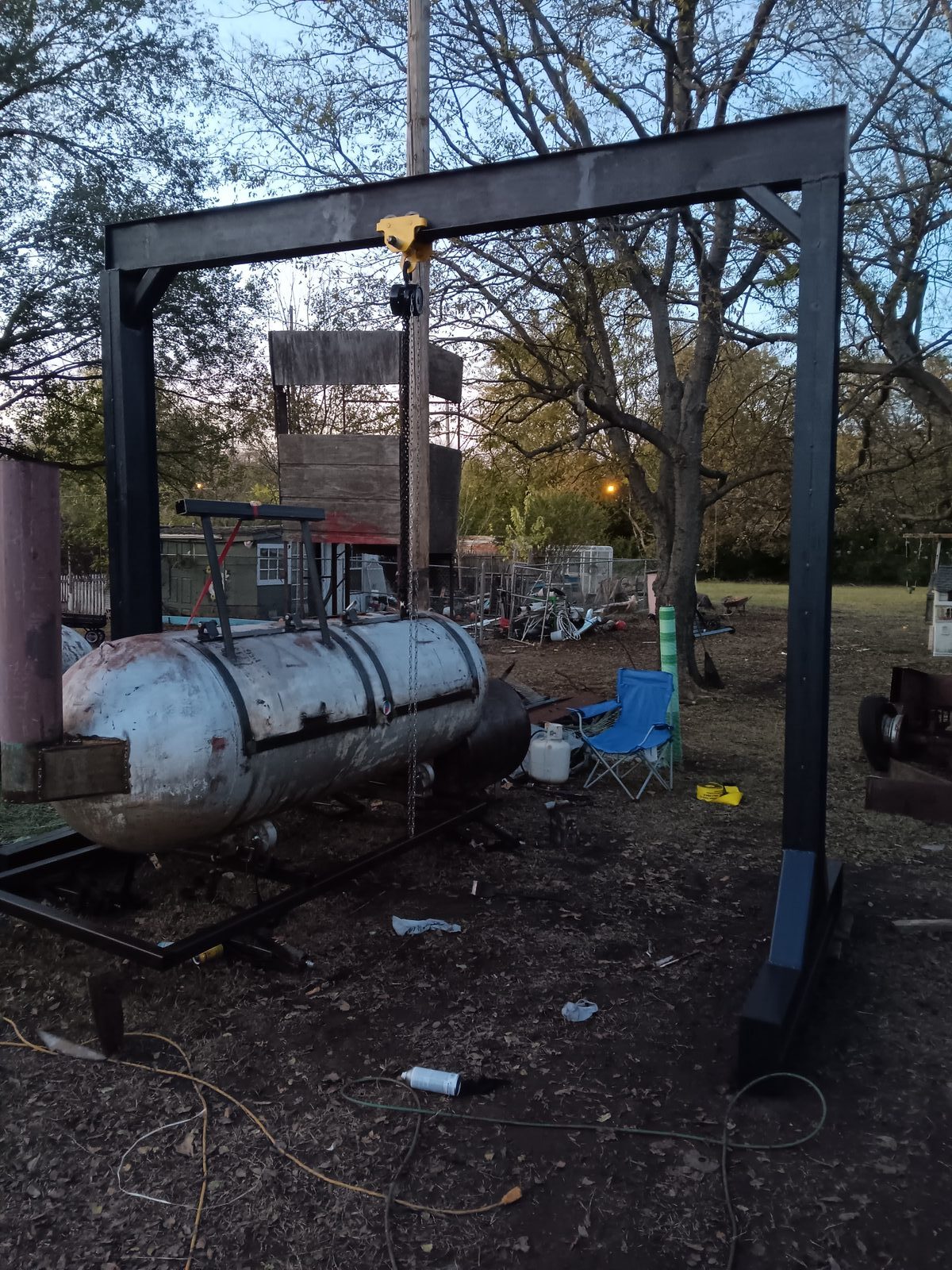 Gantry crane painted black with yellow hoist and propane tank