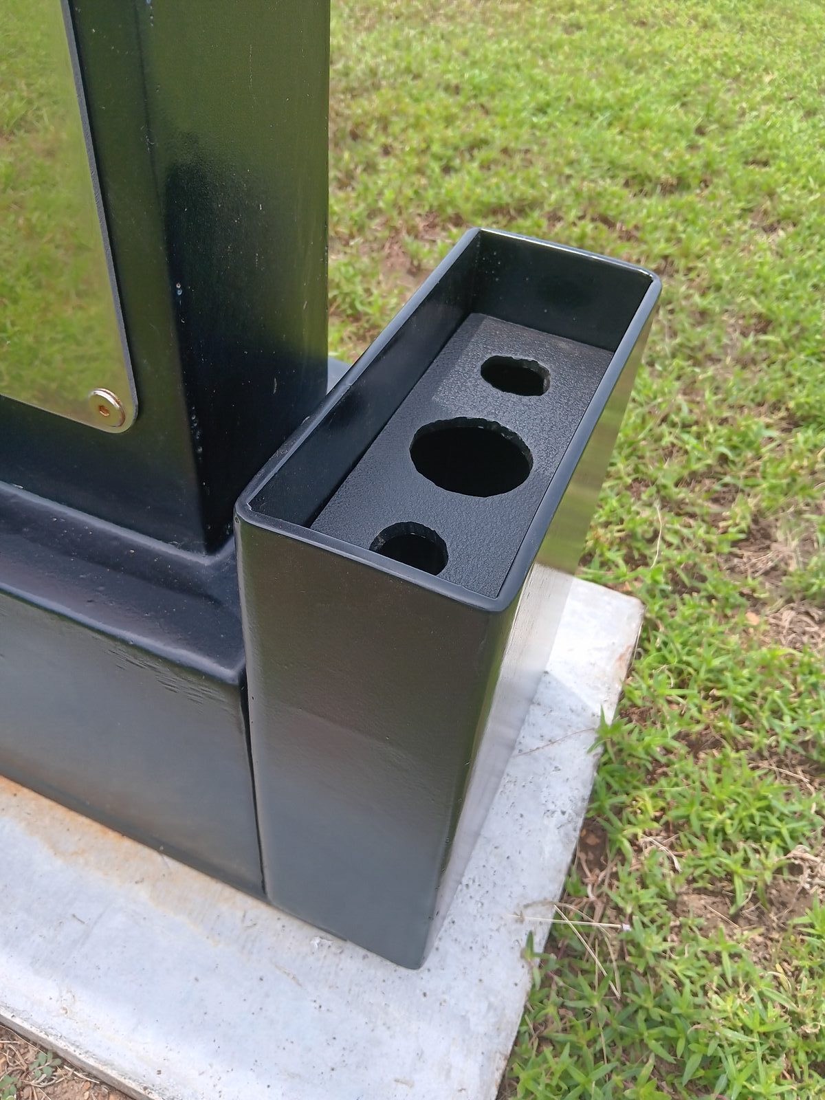 Close-up of the finished flower holder — painted and bolted in place