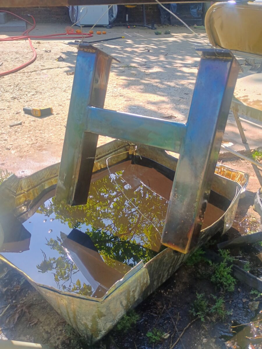 H-frame leg being quenched — tempering colors visible on the steel