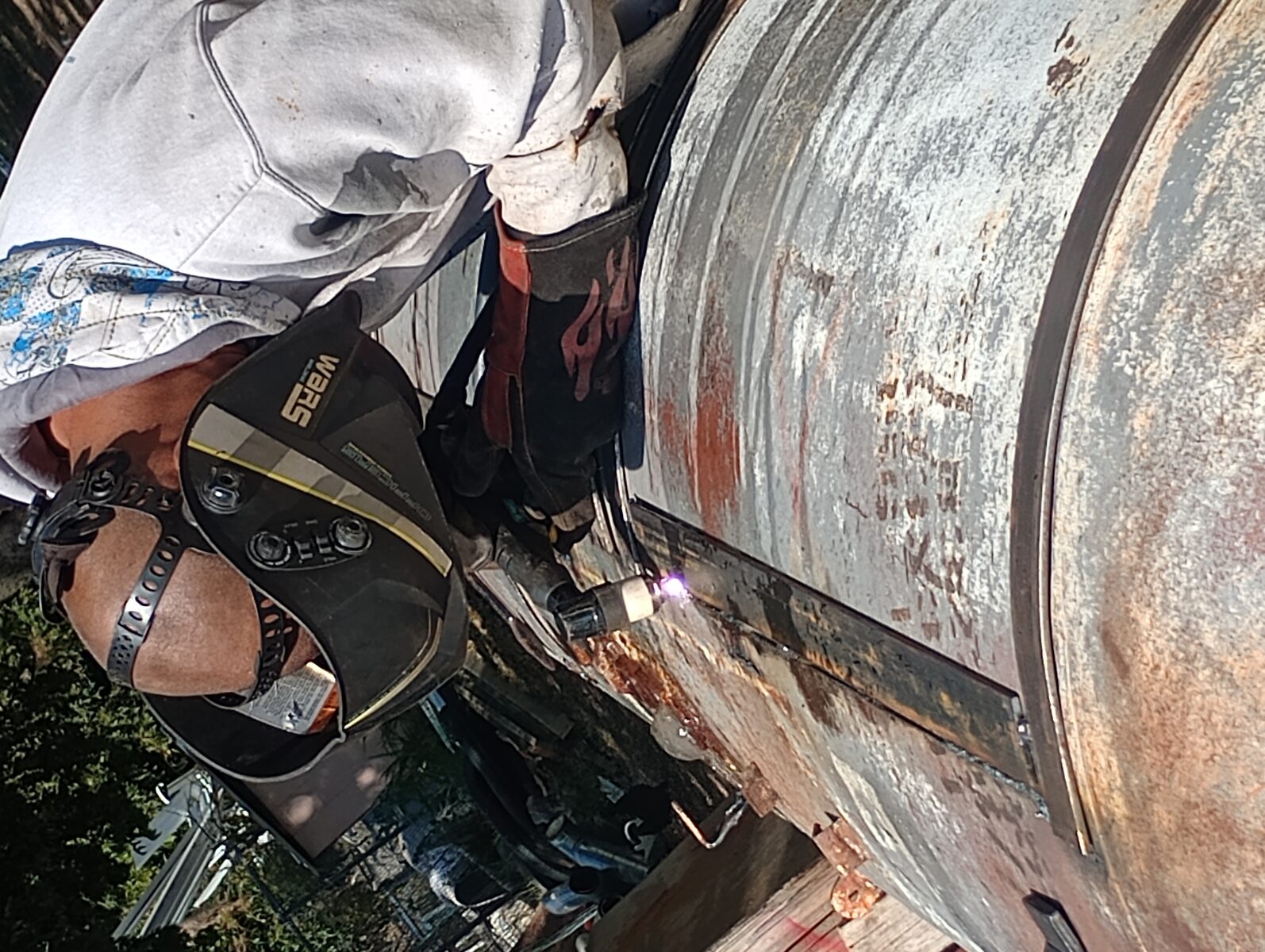 Welding on the tank — helmet, gloves, arc