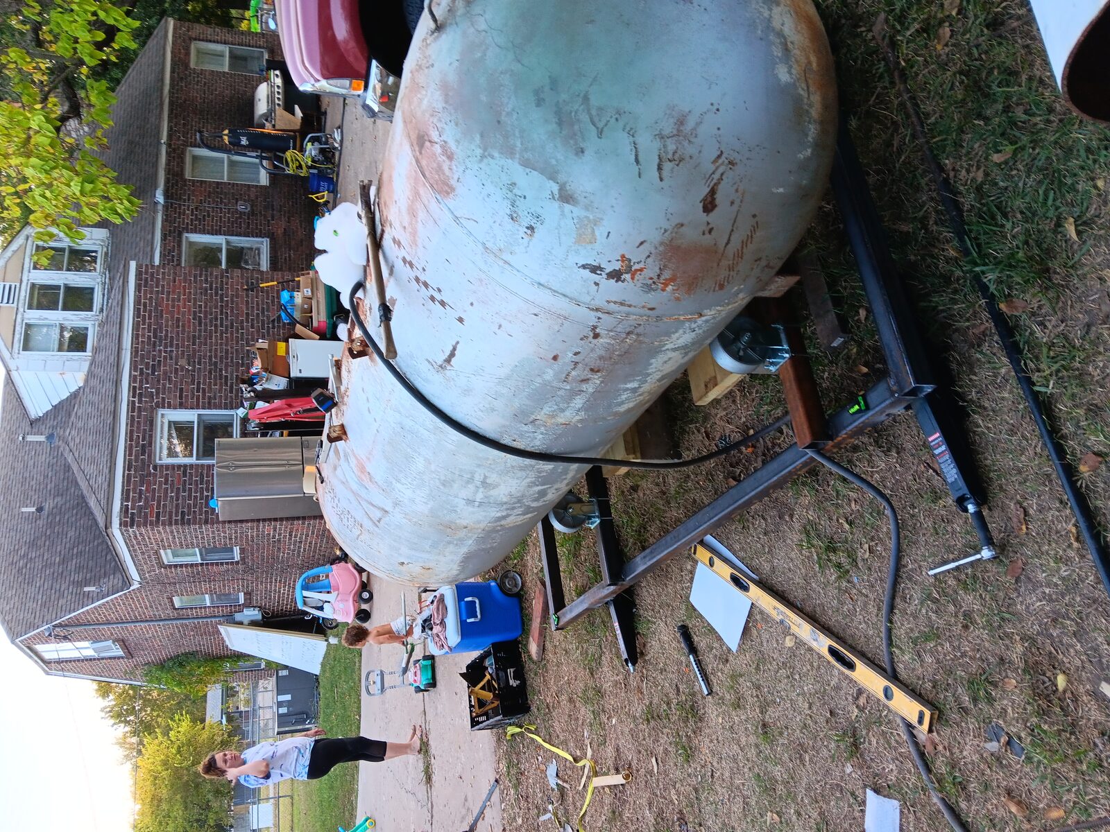 Tank mounted on the steel frame — level visible, getting it plumb