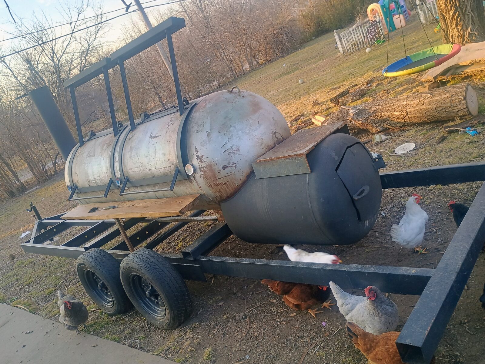 Wide shot — the full smoker rig on its trailer