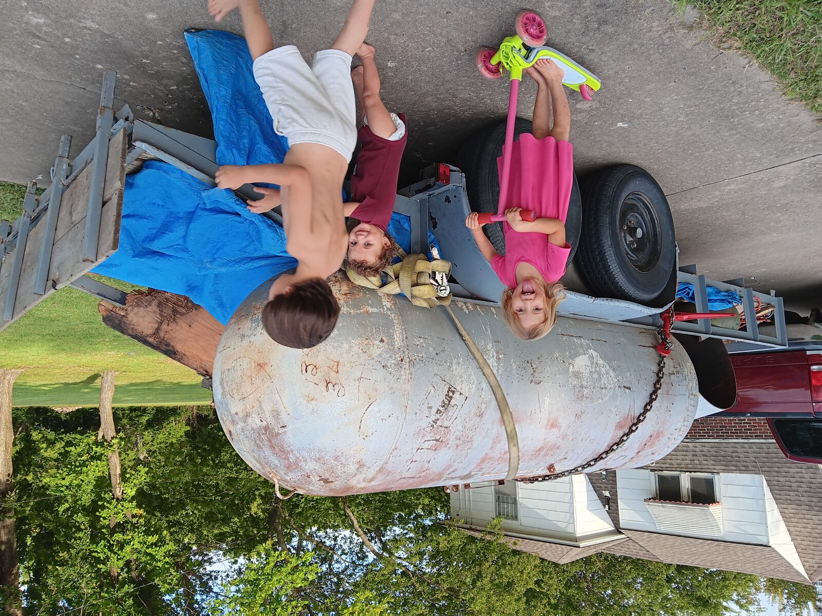 Kids sitting on the tank after unloading — already theirs