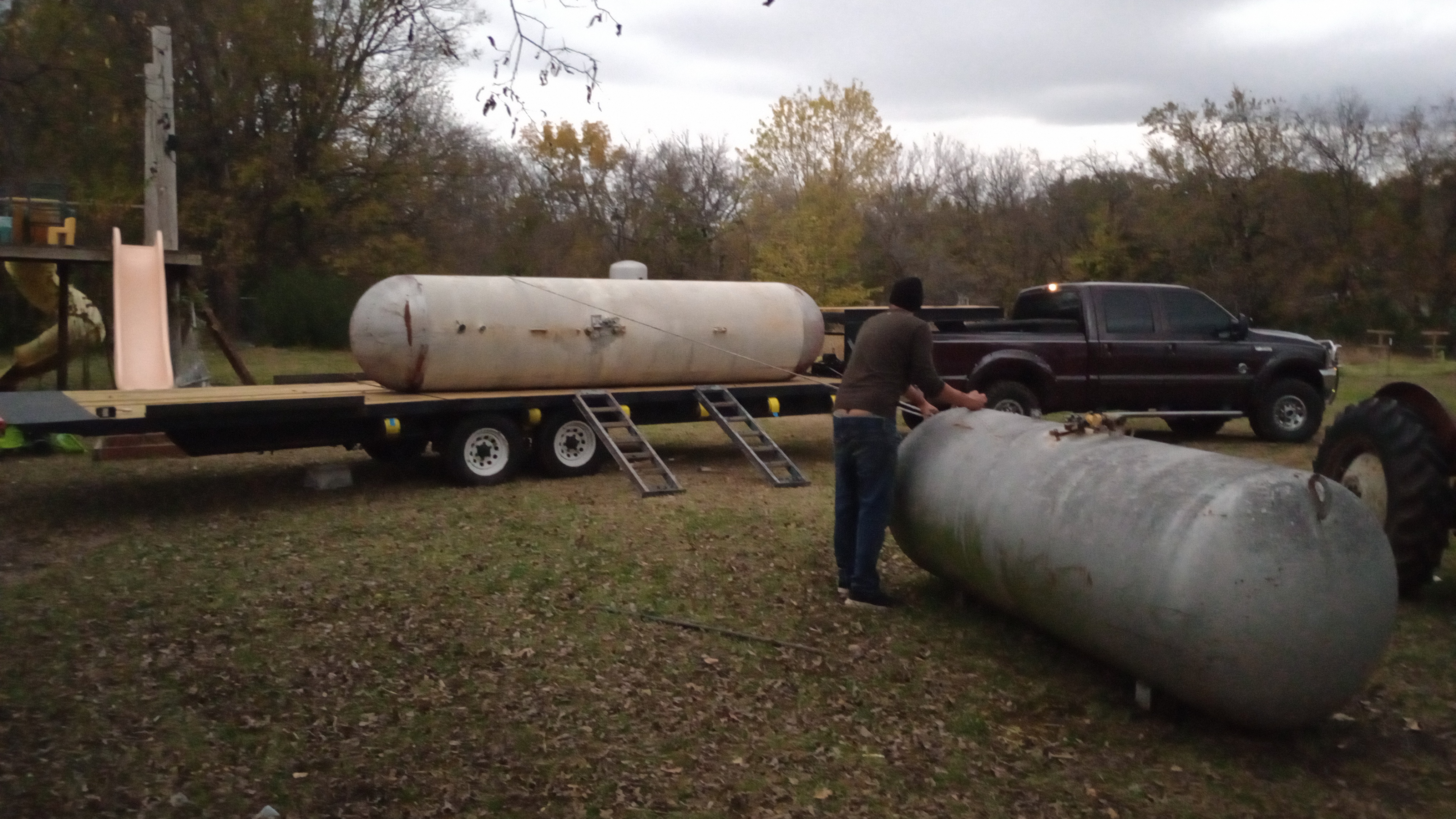 Hauling tanks home — one on the trailer, one on the ground